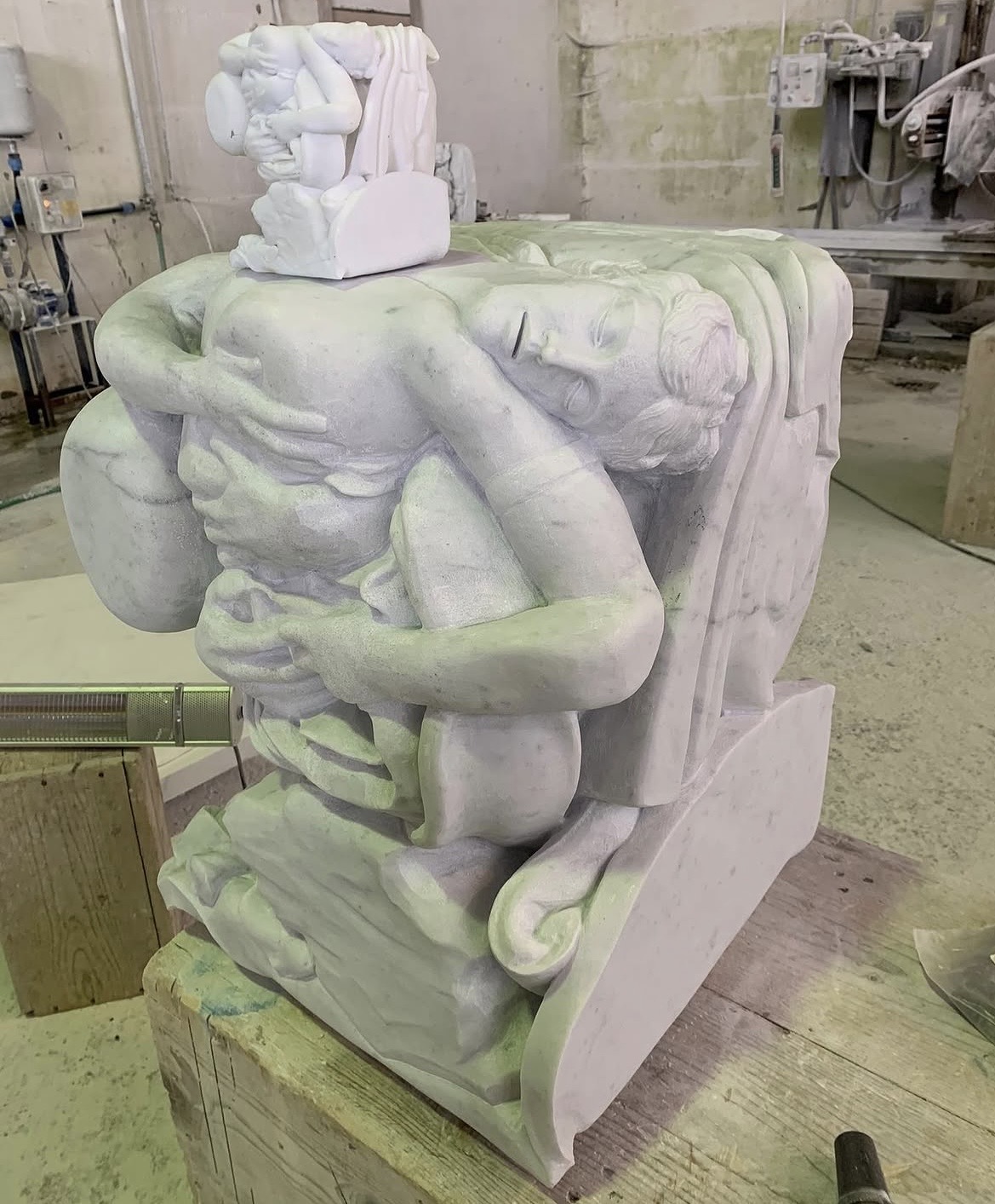 Carrara marble high relief of two embracing figures, with a smaller maquette of the same composition placed on top