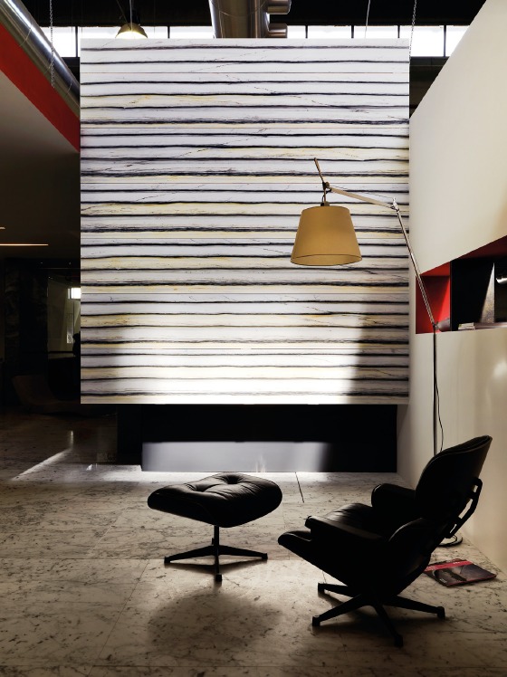 Monumental vertical slab of Carrara Zebrino marble installed as an architectural wall, showing dramatic natural veining