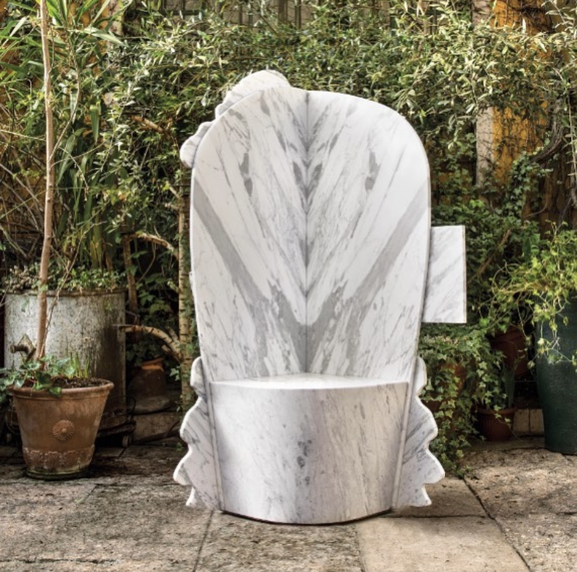 Monolithic Carrara Bianco marble throne chair with a book-matched backrest, the natural veining forming a mirrored composition