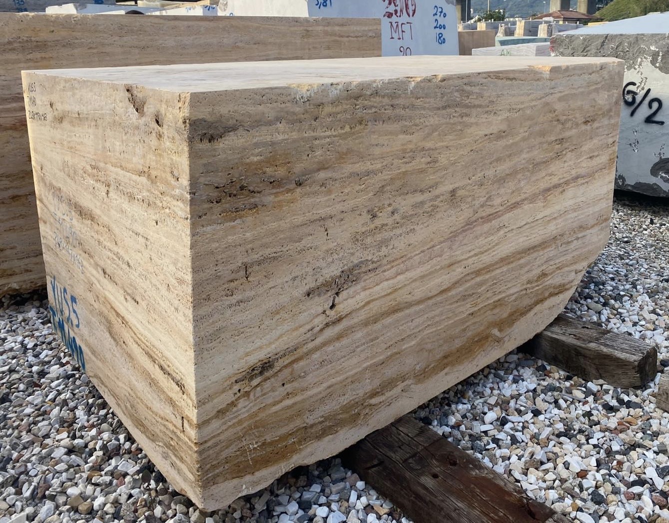 Rectangular raw block of Classic Roman Travertine showing horizontal banding and natural porosity