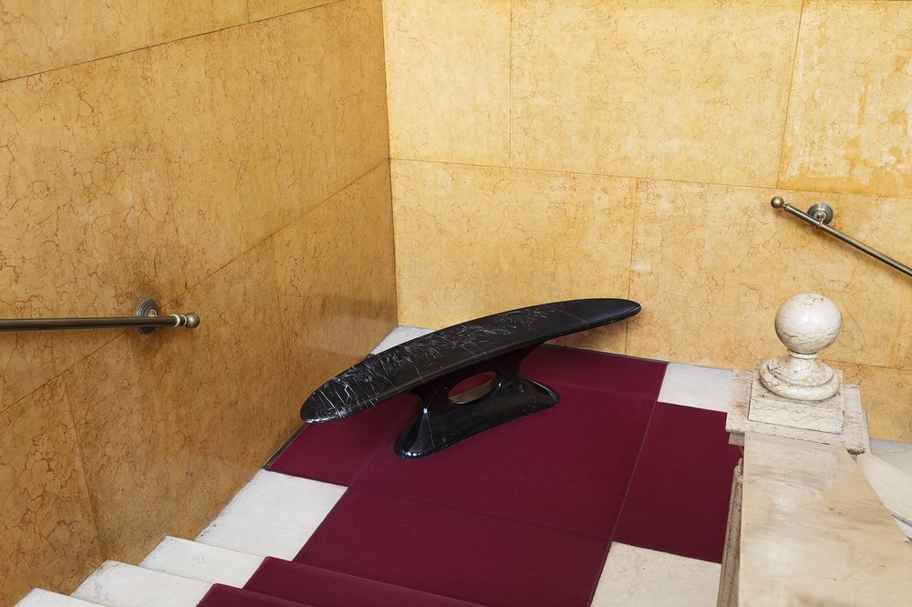 Black marble bench-object on a staircase landing